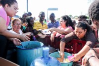 Nazarenos dan alimentos a migrantes africanos